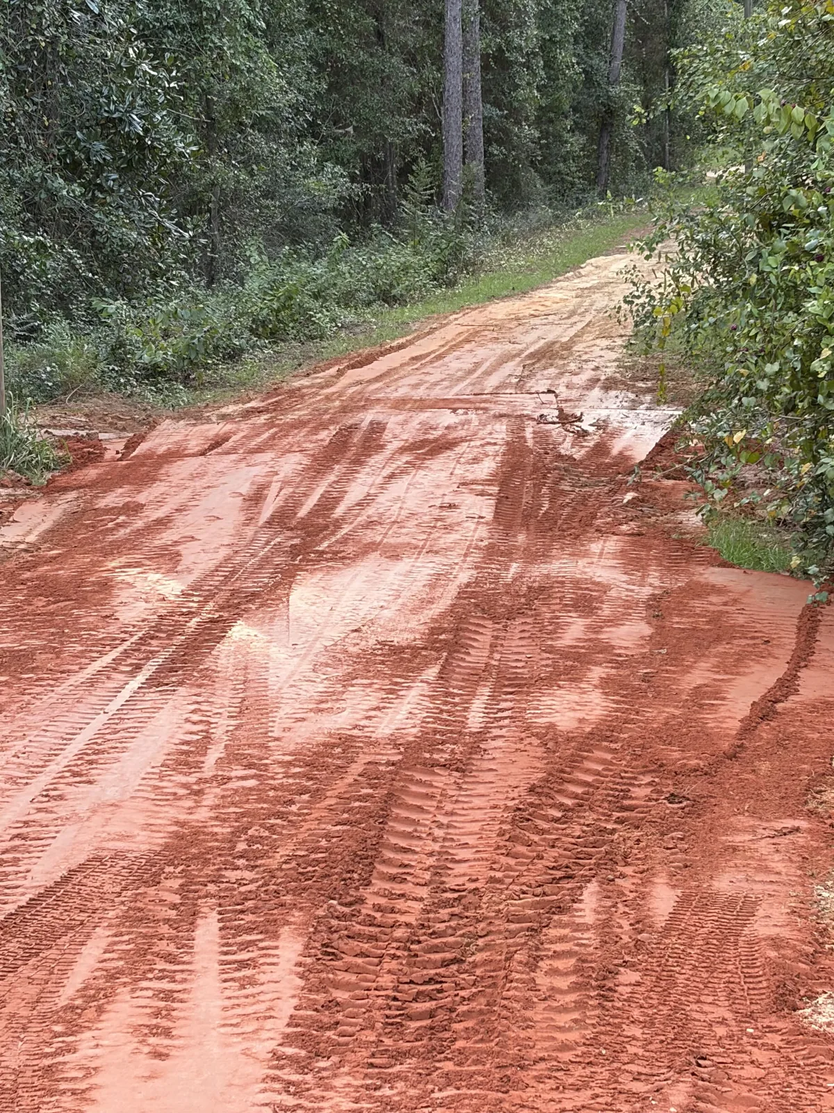 The same driveway after the washout repair, regraded and packed smooth in red clay
