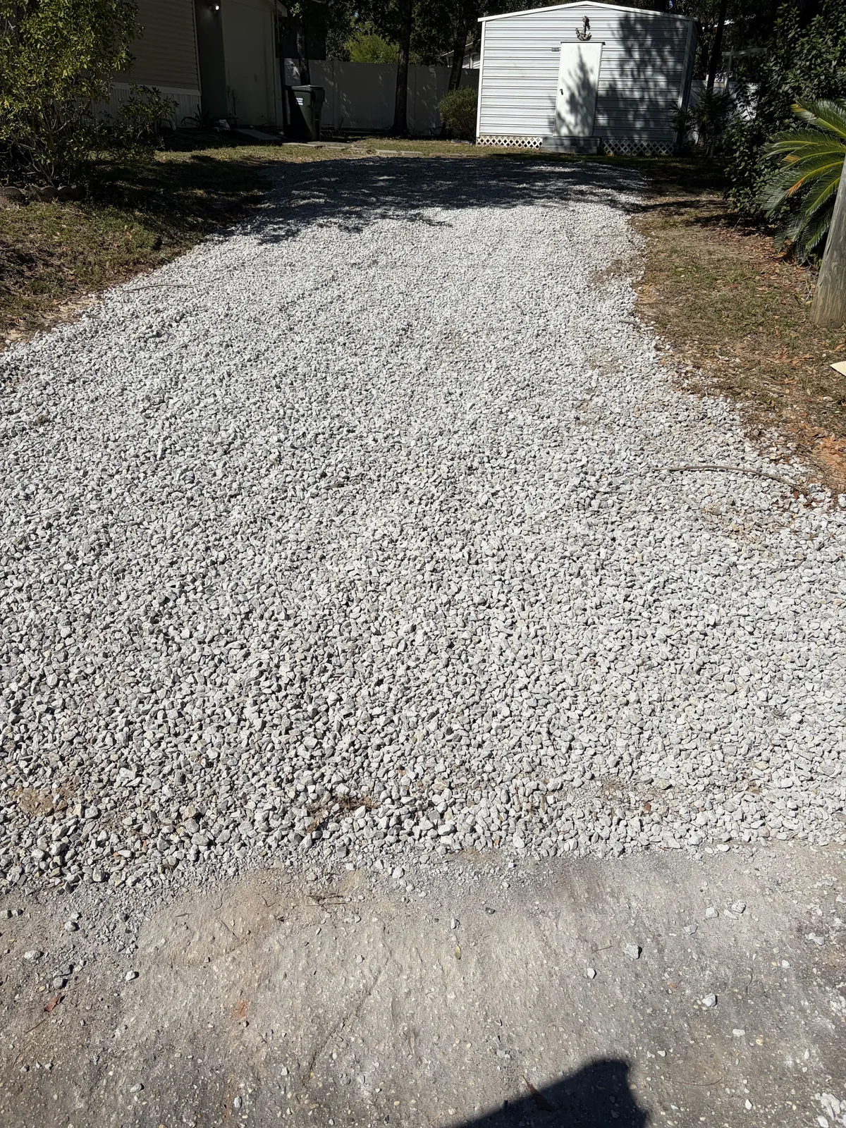 The same drive after the rehab, fresh crushed stone spread edge to edge up to the shed
